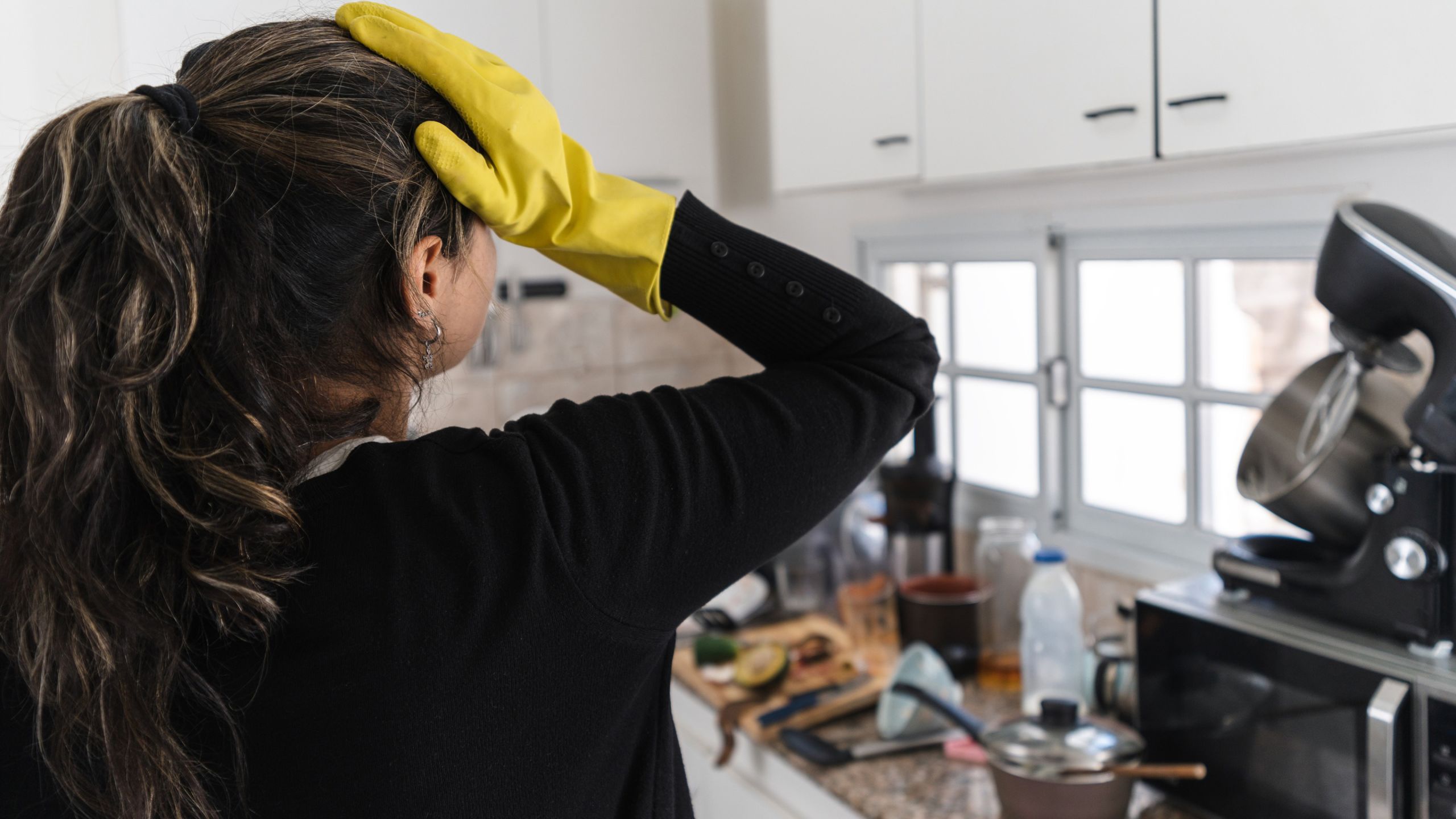 Stressed woman cleaning in the kitchen