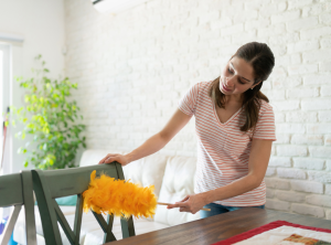 Woman dusting a chair