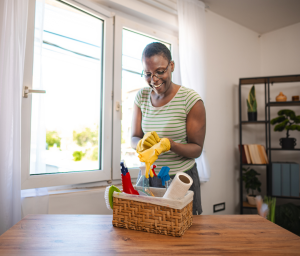 Happy person with cleaning basket
